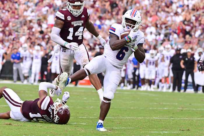 Louisiana Tech Bulldogs wide receiver Smoke Harris (6) breaks the tackle of Mississippi State Bulldogs safety Collin Duncan (19) during the second quarter at Davis Wade Stadium at Scott Field.